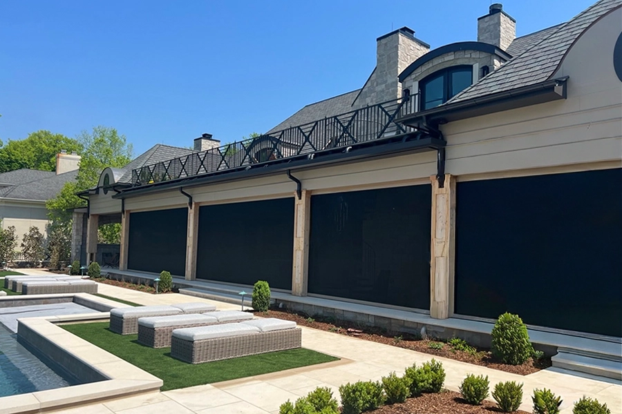 Enjoy the view from behind your retractable porch screen! Shade screens on the front of a back porch facing a pool