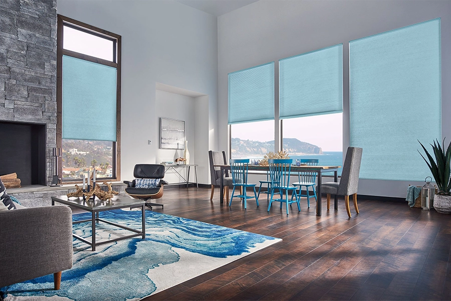 Smart motorized window shades are perfect on tall windows in your Las Vegas home. Blue motorized shades on tall living room windows