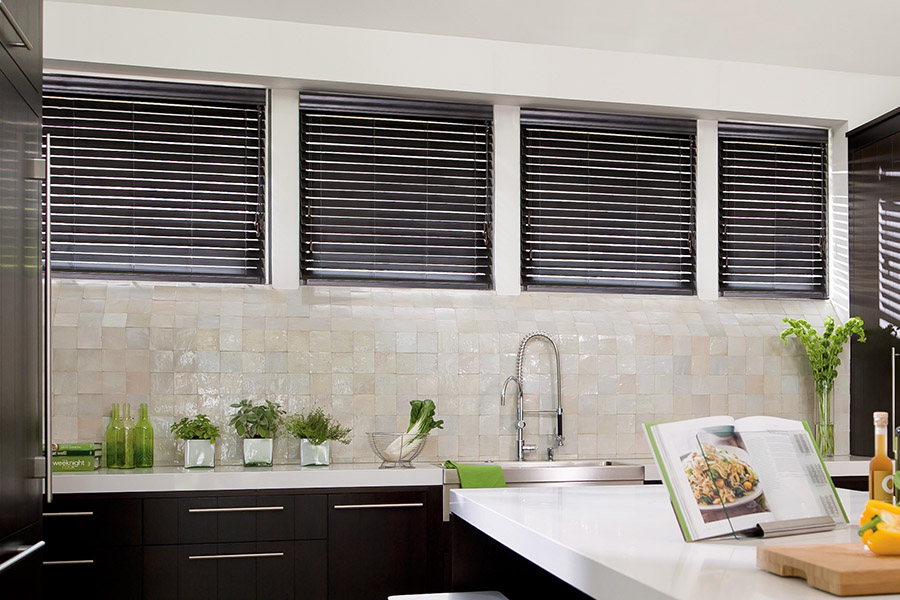 Choose custom Polywood faux wood blinds for your kitchen in Las Vegas. Special shaped faux wood blinds in several windows above a sink.