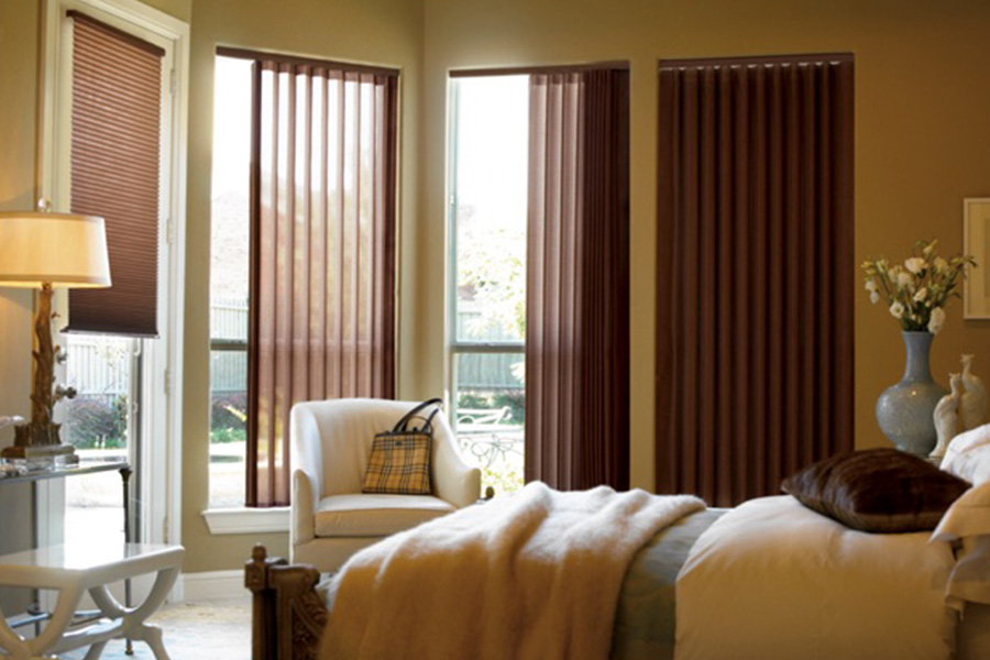 Choose durable and high-quality fabric or vinyl vertical blinds in Las Vegas. Maroon fabric vertical blinds inside a bedroom